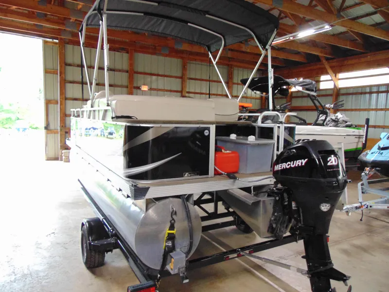 Slide: The Image of 2012 Apex Marine 1716 pontoon boat with Mercury 20HP engine in a storage facility. - 3