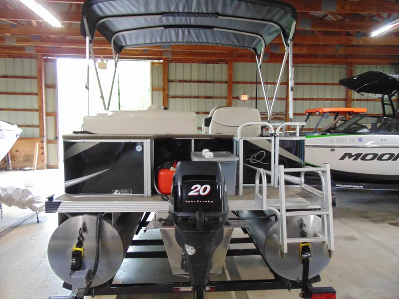 Slide: The Image of 2012 Apex Marine 1716 pontoon boat with canopy in a storage facility. - 4