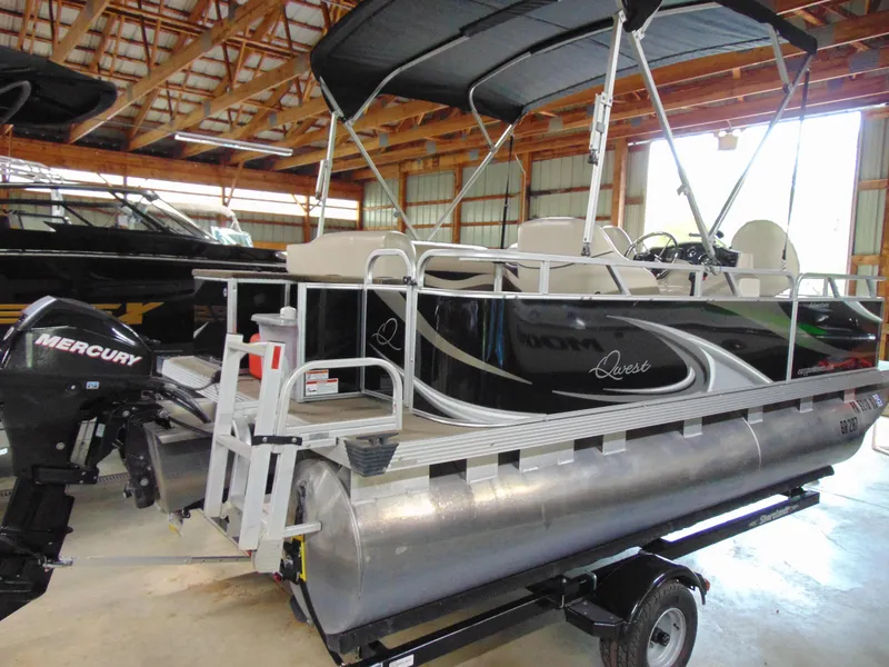 Slide: The Image of 2012 Apex Marine 1716 pontoon boat with Mercury outboard motor in a storage facility. - 6