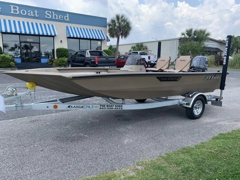 The Image of 2025 SeaArk Shadow 17 Side Console boat on trailer outside dealership. - 0