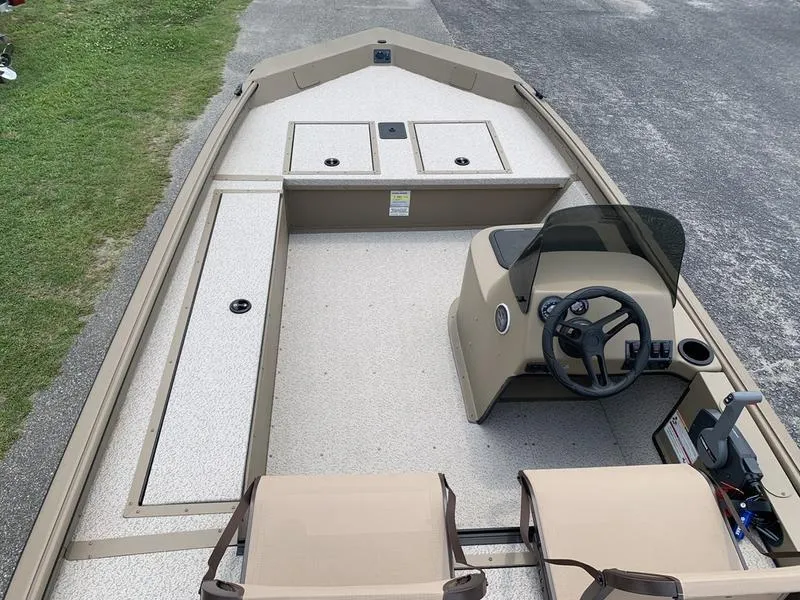 Slide: The Image of 2025 SeaArk Shadow 17 Side Console boat interior with steering wheel and seating. - 10