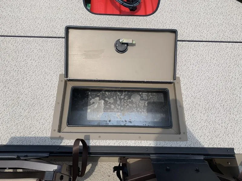 Slide: The Image of 2025 SeaArk Shadow 17 Side Console boat with open storage compartment. - 11