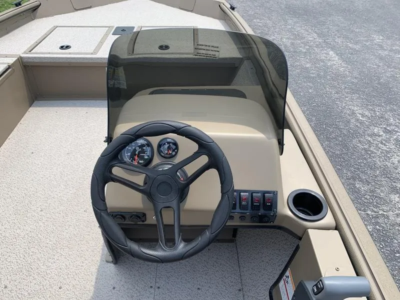 Slide: The Image of 2025 SeaArk Shadow 17 Side Console boat interior with steering wheel and dashboard controls. - 12