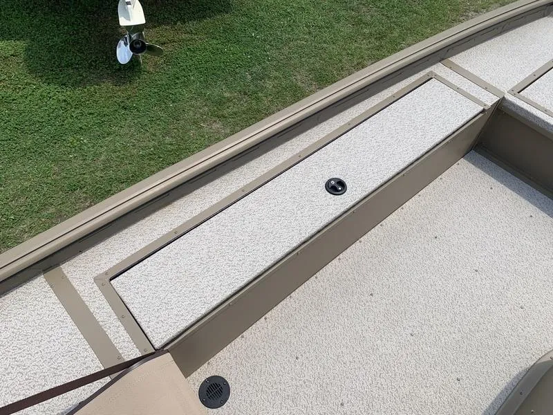 Slide: The Image of 2025 SeaArk Shadow 17 Side Console boat deck with storage compartment. - 13