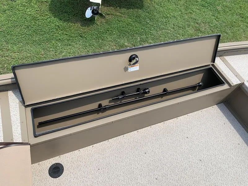 Slide: The Image of 2025 SeaArk Shadow 17 Side Console boat storage compartment with fishing rods. - 14