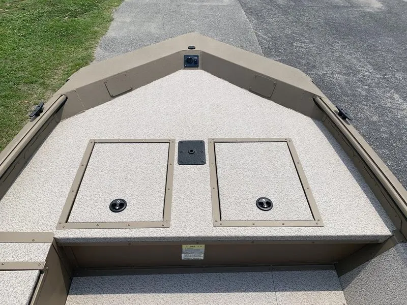 Slide: The Image of 2025 SeaArk Shadow 17 Side Console boat deck with storage compartments. - 17