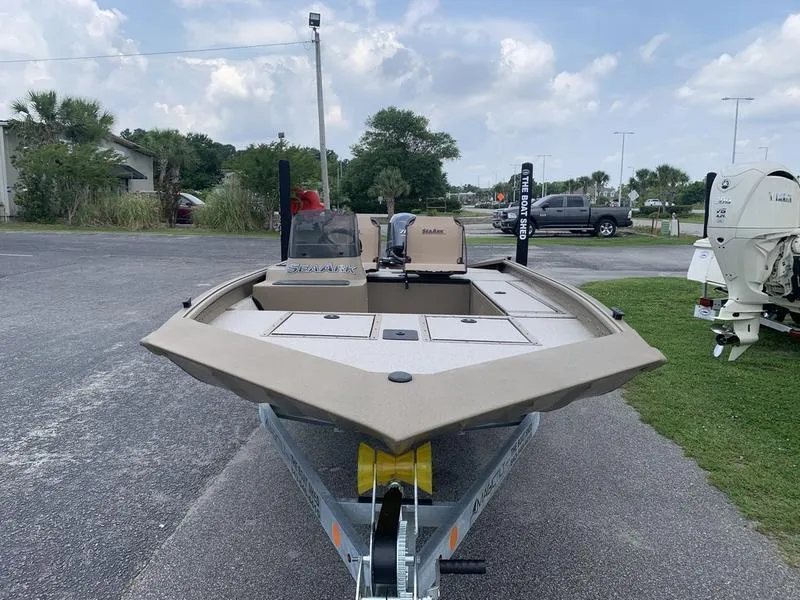Slide: The Image of 2025 SeaArk Shadow 17 Side Console boat on trailer, parked outdoors. - 6