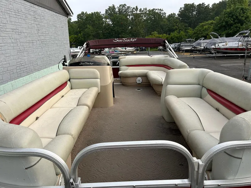 Slide: The Image of 2012 Sun Tracker Party Barge 22 DLX with spacious seating and canopy, docked outdoors. - 4