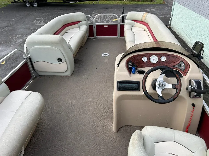 Slide: The Image of 2012 Sun Tracker Party Barge 22 DLX interior with seating and steering console. - 6