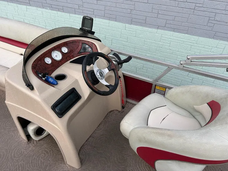 Slide: The Image of 2012 Sun Tracker Party Barge 22 DLX helm with steering wheel and gauges. - 7