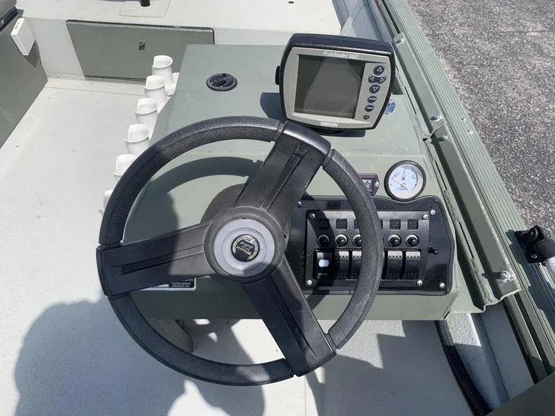 Slide: The Image of Steering console of 2007 Triton 1756S boat with fishfinder and controls. - 11