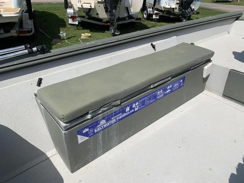 Slide: The Image of 2007 Triton 1756S boat interior with cushioned bench and storage compartment. - 13