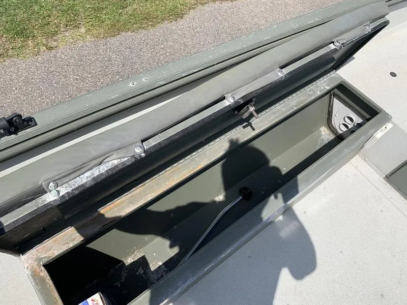 Slide: The Image of Open storage compartment in a 2007 Triton 1756S boat, showing interior details. - 14