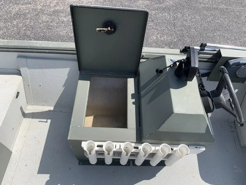 Slide: The Image of Open storage compartment on 2007 Triton 1756S boat with rod holders. - 16