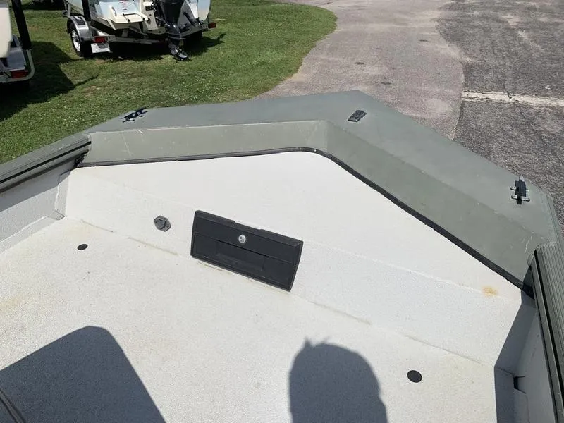 Slide: The Image of 2007 Triton 1756S boat interior with gray deck and storage compartment. - 18