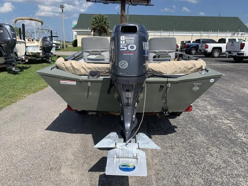 Slide: The Image of 2007 Triton 1756S boat with Yamaha 50HP outboard motor, parked outdoors. - 2