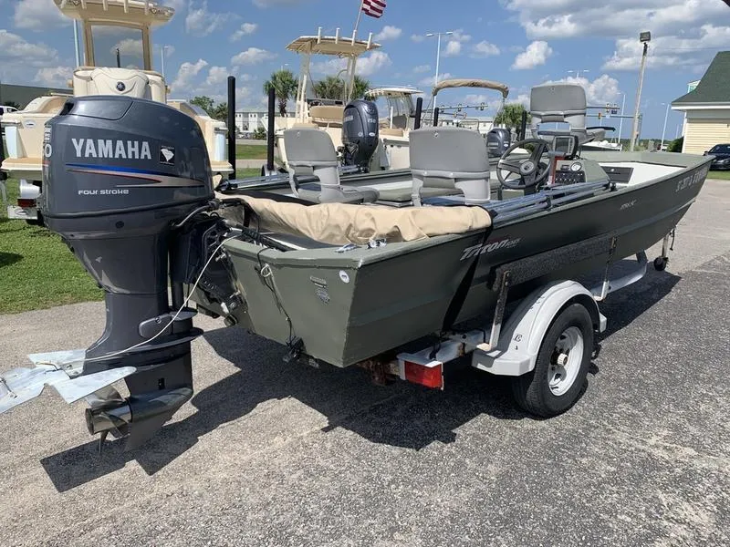 Slide: The Image of 2007 Triton 1756S boat with Yamaha outboard motor on a trailer, parked outdoors. - 3