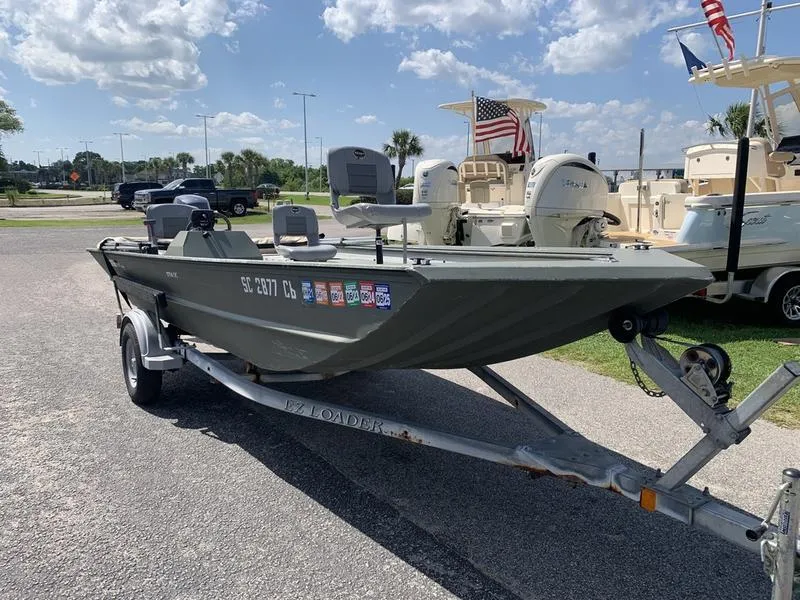 Slide: The Image of 2007 Triton 1756S boat on trailer, parked outdoors under a partly cloudy sky. - 5