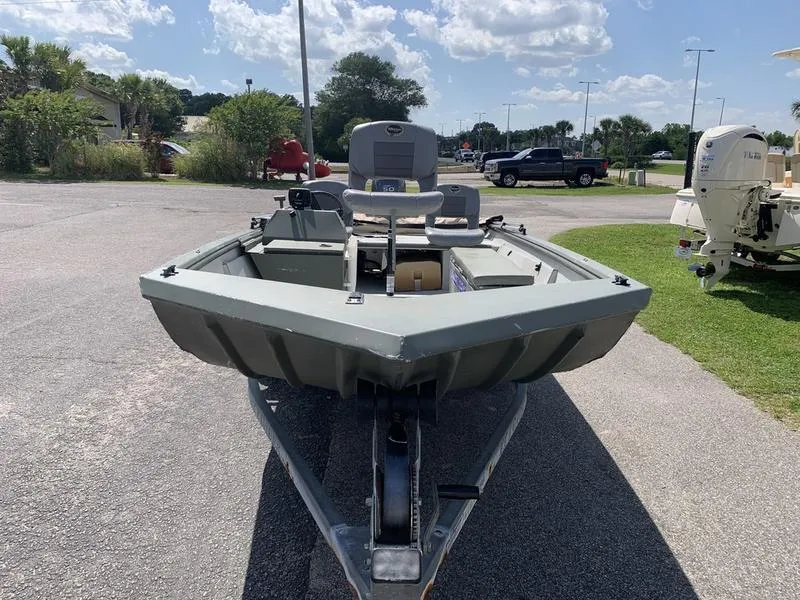 Slide: The Image of 2007 Triton 1756S boat on trailer in sunny outdoor setting. - 6