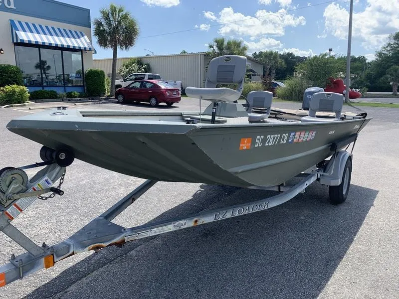 Slide: The Image of 2007 Triton 1756S boat on trailer in sunny parking lot. - 7