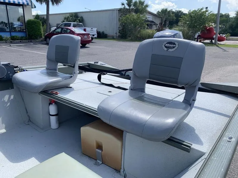 Slide: The Image of 2007 Triton 1756S boat with two gray seats in a parking lot. - 8