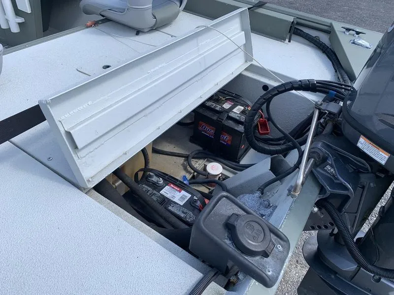 Slide: The Image of 2007 Triton 1756S boat showing open battery compartment and engine components. - 9