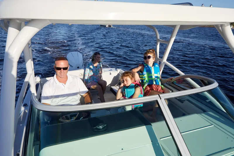 Slide: The Image of Family enjoying a ride on a 2024 Finseeker 240 WA boat. - 10