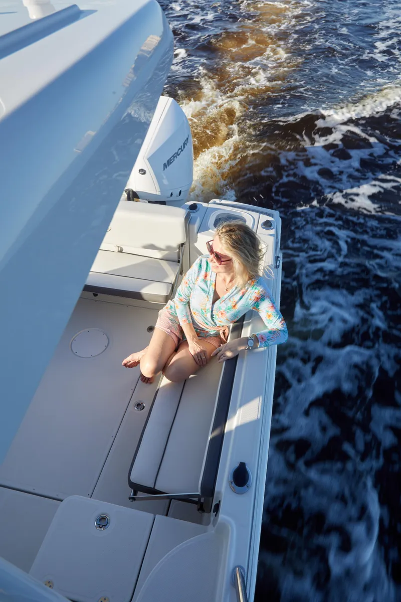 Slide: The Image of Woman relaxing on 2024 Finseeker 240 WA boat, enjoying sunny day on the water. - 11
