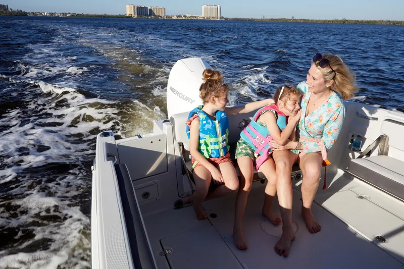 Slide: The Image of Family enjoying a ride on a 2024 Finseeker 240 WA boat. - 12