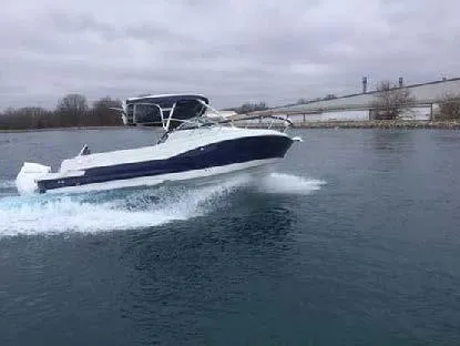 Slide: The Image of 2024 Finseeker 240 WA boat cruising on a lake under cloudy skies. - 2