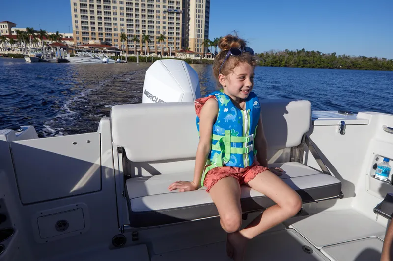 Slide: The Image of Young girl in life jacket on 2024 Finseeker 240 WA boat, enjoying a sunny day. - 7
