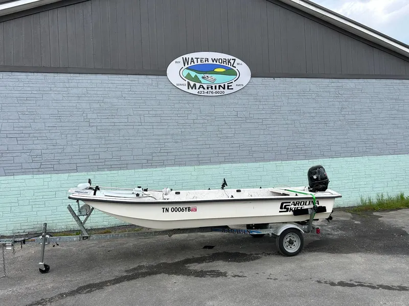 Slide: The Image of 2004 Carolina Skiff J1650 boat on trailer outside Water Workz Marine. - 1