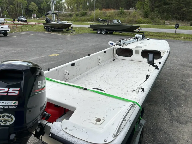 Slide: The Image of 2004 Carolina Skiff J1650 boat with Suzuki 25 outboard motor in parking lot. - 7