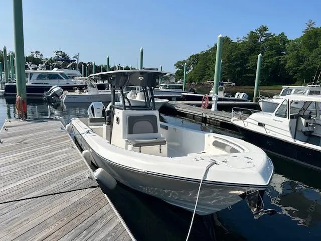 Slide: The Image of 2022 Sea Born LX26 Center Console boat docked at marina, surrounded by other vessels. - 1
