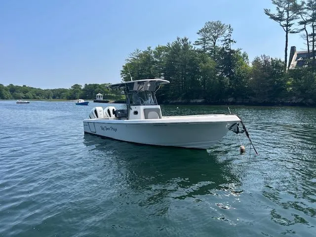 Slide: The Image of 2022 Sea Born LX26 Center Console boat on calm water near a wooded shoreline. - 10