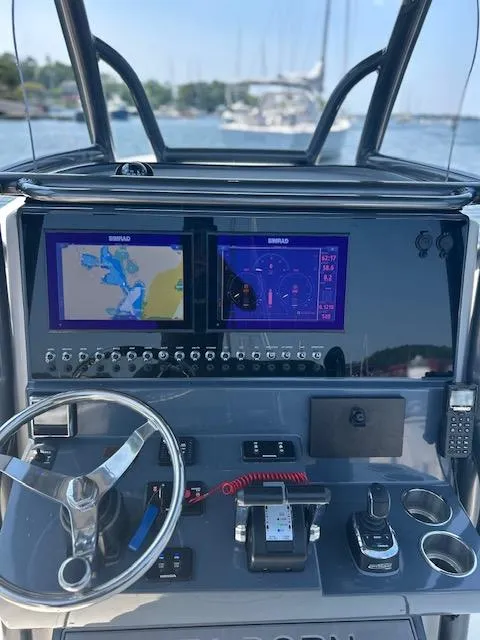 Slide: The Image of 2022 Sea Born LX26 Center Console dashboard with navigation screens and controls. - 11