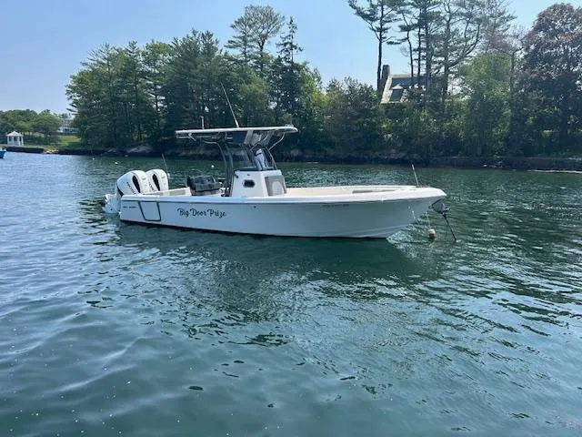 Slide: The Image of 2022 Sea Born LX26 Center Console boat on calm water near a wooded shoreline. - 12