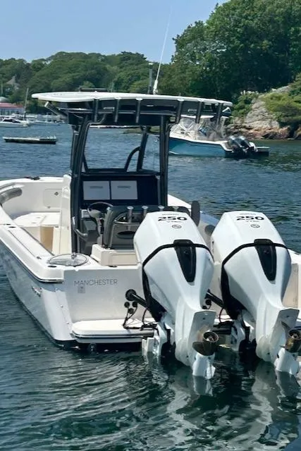 Slide: The Image of 2022 Sea Born LX26 Center Console boat with twin engines on a scenic waterway. - 15