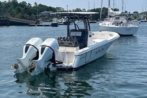 Slide: The Image of 2022 Sea Born LX26 Center Console boat with twin engines on calm water. - 16