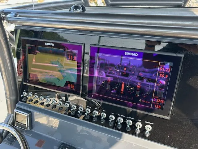 Slide: The Image of 2022 Sea Born LX26 Center Console dashboard with dual Simrad displays. - 2