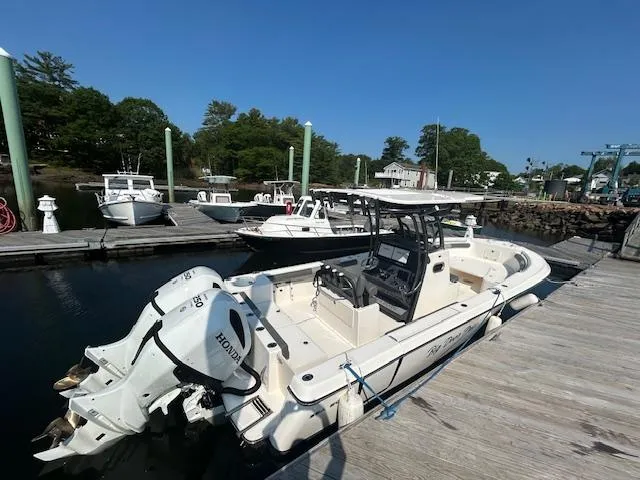 Slide: The Image of 2022 Sea Born LX26 Center Console boat docked with Honda outboard motor. - 3