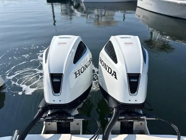 Slide: The Image of Twin Honda 250 outboard engines on a 2022 Sea Born LX26 Center Console boat. - 4