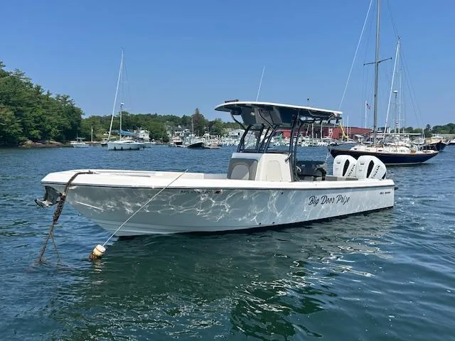 Slide: The Image of 2022 Sea Born LX26 Center Console boat on calm water, sunny day, marina background. - 5
