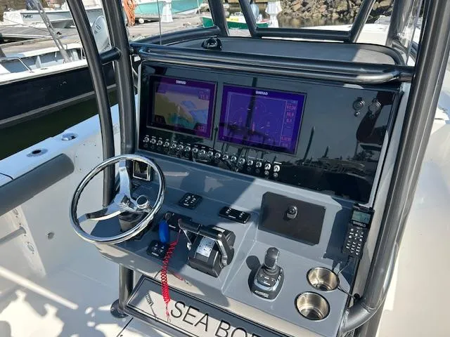 Slide: The Image of 2022 Sea Born LX26 Center Console dashboard with dual screens and steering wheel. - 6