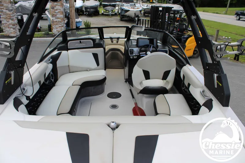 Slide: The Image of 2017 Malibu Wakesetter 20 VTX interior with white and black seating, dashboard, and steering wheel. - 10