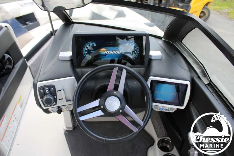 Slide: The Image of 2017 Malibu Wakesetter 20 VTX dashboard with digital displays and steering wheel. - 14