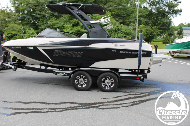 Slide: The Image of 2017 Malibu Wakesetter 20 VTX boat on trailer, parked outdoors, with Chessie Marine logo. - 7