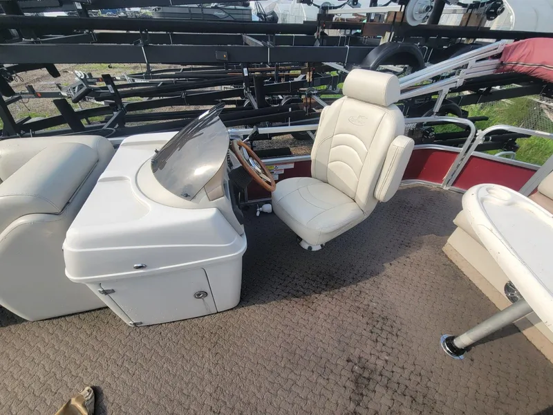 Slide: The Image of 2011 Misty Harbor 2285 DR boat interior with captain's chair and steering console. - 10