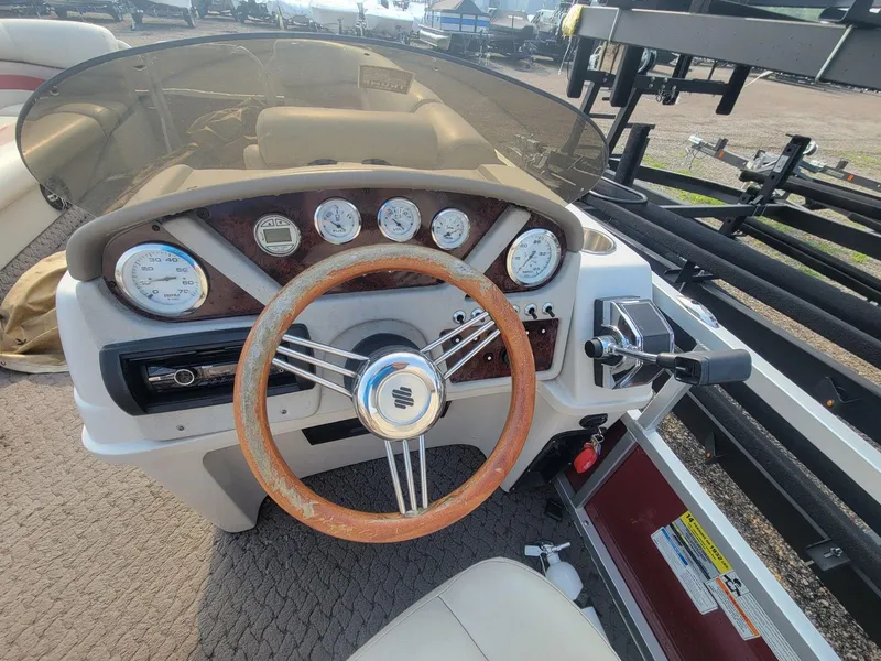 Slide: The Image of Steering console of 2011 Misty Harbor 2285 DR boat with gauges and controls. - 11