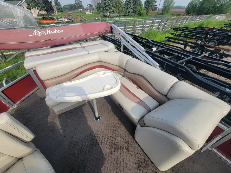 Slide: The Image of 2011 Misty Harbor 2285 DR pontoon boat with beige seating and a small table. - 12